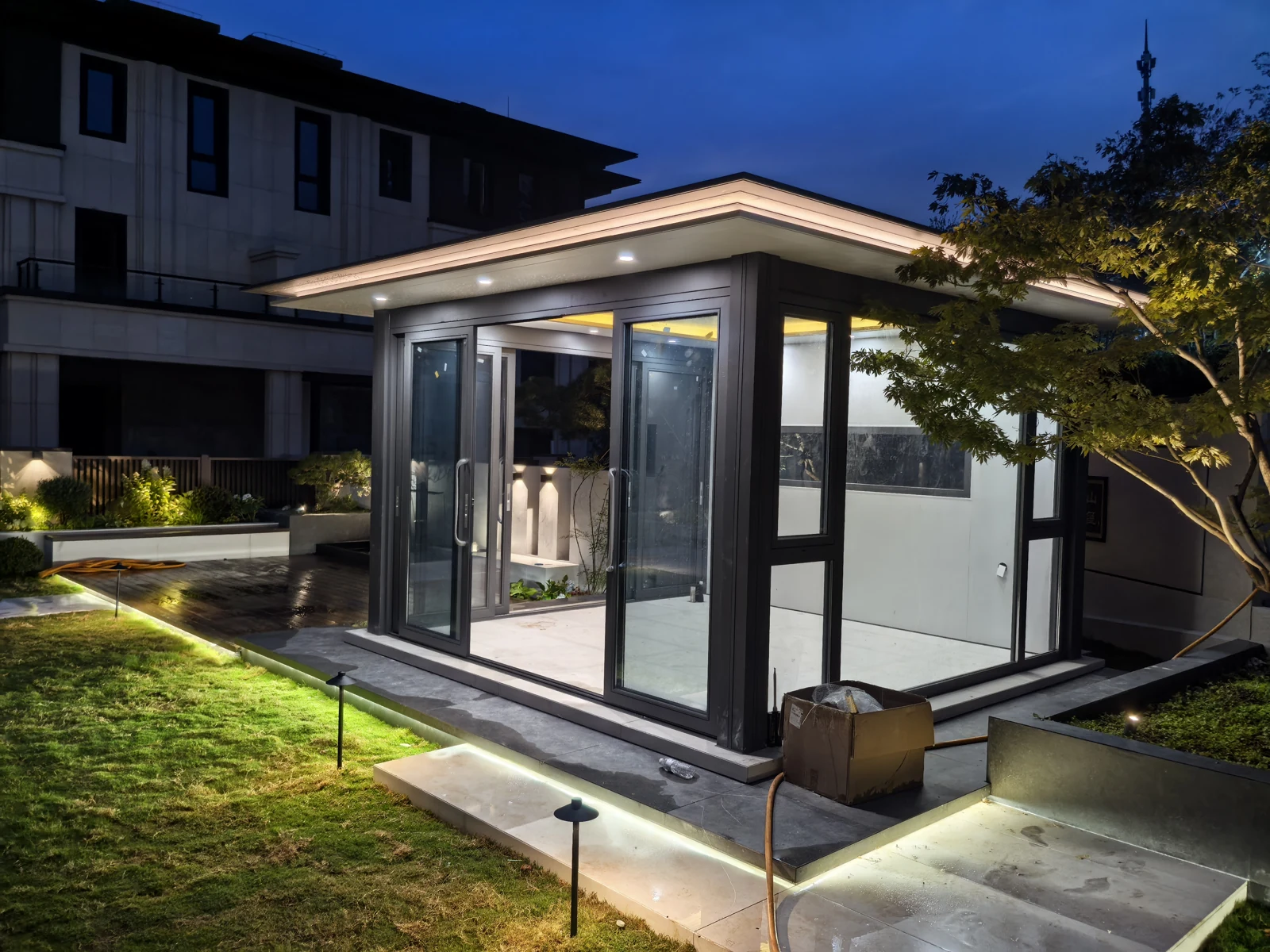 Original site photograph of the enclosed garden room in Tai’an, with courtyard paving and garden planting
