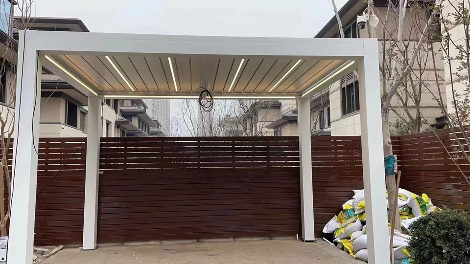 Front view of a white pergola with roof lighting, loose wiring and installation materials visible