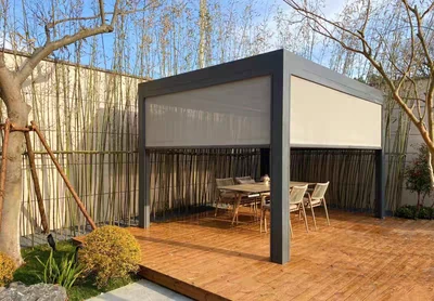 Grey pergola with partially lowered side screens on a timber terrace.